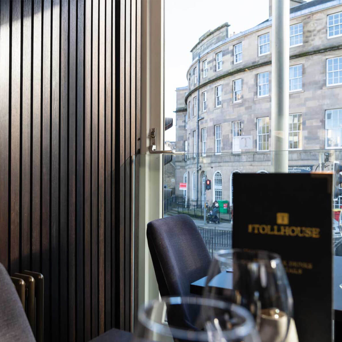 A window table at The Tollhouse looking out onto a curved Georgian stone crescent at Canonmills
