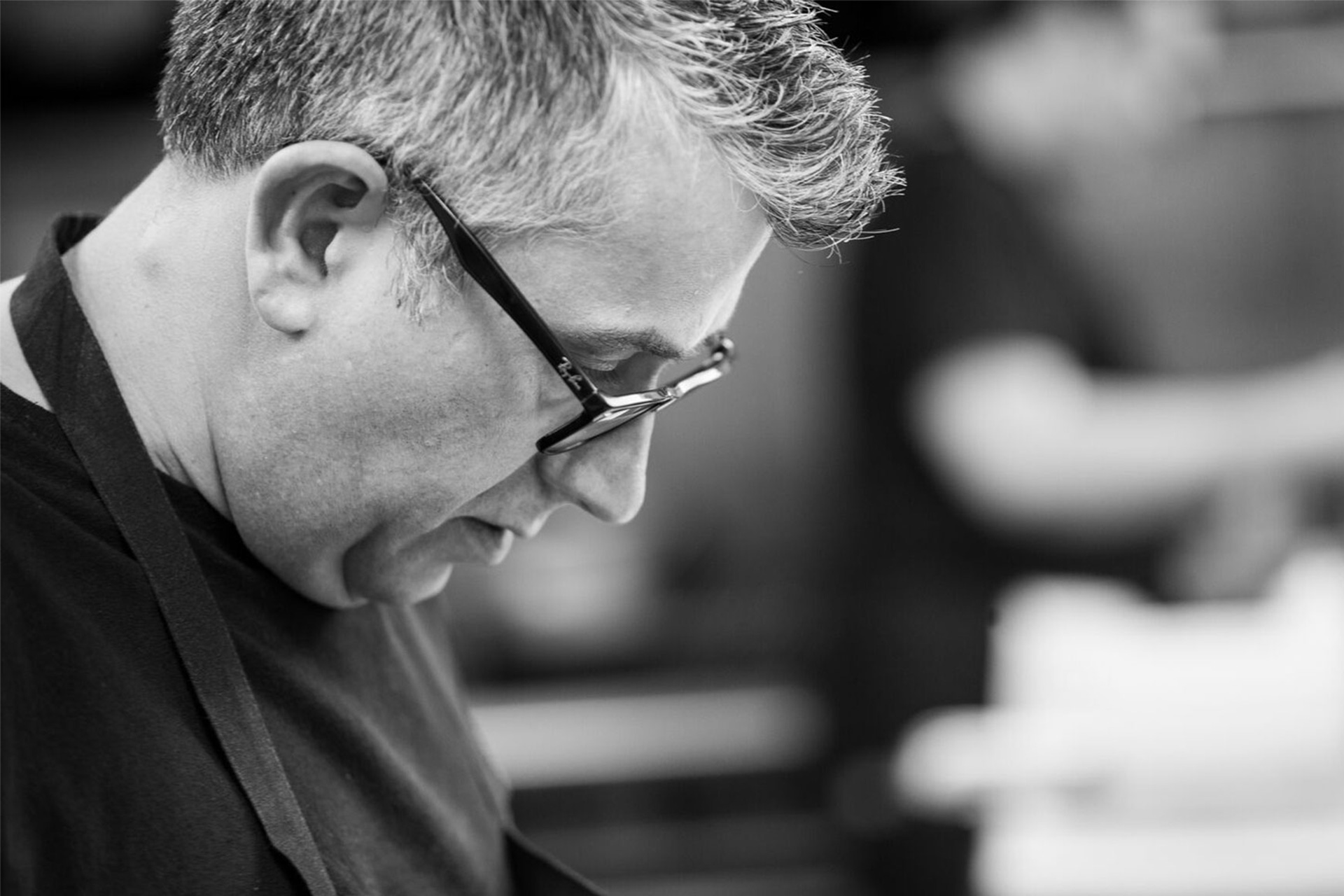 Michelin-starred chef Stuart Muir at work in the kitchen, in black and white